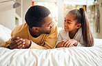 Family, father and girl child talking, spending quality time together with love and care, relax in bedroom at home. Black man, child and happy people, communication and relationship with childhood