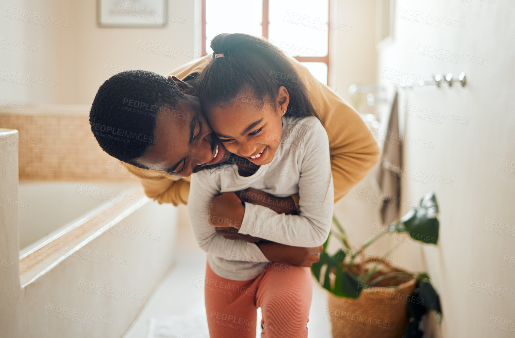 Buy stock photo Black family, father and child for a hug in happy home with love, care and support in bathroom. Man and girl kid together for happiness with smile, energy and embrace for safety, health and wellness