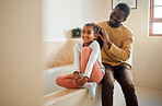 Excited child, father and brushing hair in family home bathroom with love and support. Black man teaching child self care, health tips and wellness with communication, talking about trust and beauty