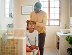Father, daughter and brushing hair in a home bathroom with love, trust and support. Man teaching child self care, health tips and wellness with communication, talking about confidence and respect