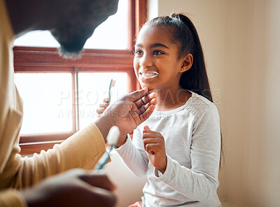 Buy stock photo Dental health, father and daughter brushing teeth in a bathroom for hygiene, grooming and bonding. Oral, care and  girl with parent, teeth and cleaning while having fun, playful and smile at home