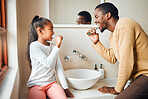 Brushing teeth, dental health and father with daughter in a bathroom for hygiene, grooming and bonding. Oral care, girl and parent, teeth and cleaning while having fun, playful and smile at home