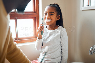 Buy stock photo Daughter, father and brushing teeth in a bathroom for hygiene, grooming and bonding. Oral care, girl and parent for morning cleaning while having fun with black family who laugh and smile at home