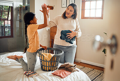 Buy stock photo Cleaning, high five and child and mother doing laundry clothes, house work and fold clean fabric. Love bond, home bedroom or happy family kid with basket container and celebrate domestic housekeeping