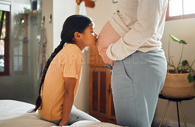 Buy stock photo Pregnant, family and love with a girl kissing the belly of her mother while bonding in the bedroom of their home. Kids, mom and pregnancy with a kiss by an indian daughter to the stomach of her mama