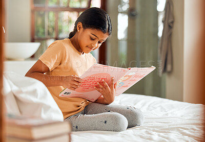 Buy stock photo Smart child reading story for home learning, language and creative education development on her bed. Happy, kindergarten Indian girl kid with English books for knowledge, hobby and fun house activity