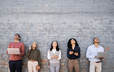 Buy stock photo Diversity, technology and team standing at wall looking up and working at tech development company waiting for hr. Human resources, job opportunity and group of people with laptop, phone and tablet.