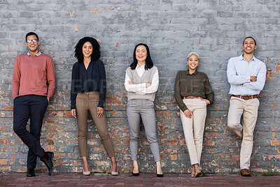 Buy stock photo Portrait, collaboration and goals with a business team standing together, leaning on a brick wall. Teamwork, mindset and vision with a man and woman employee group outside for future success