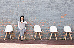 Waiting, interview and woman check time for recruitment, job opportunity and human resources feedback. Asian person alone on chair looking at watch for career news, feedback and appointment schedule
