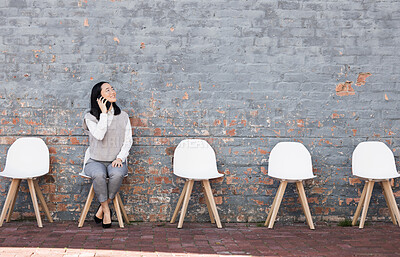 Buy stock photo Phone call, thinking in waiting room and woman with chairs, job recruitment and employment with smile in Japan. Happy person sitting on chair with smartphone, smiling and talking  with mockup space.