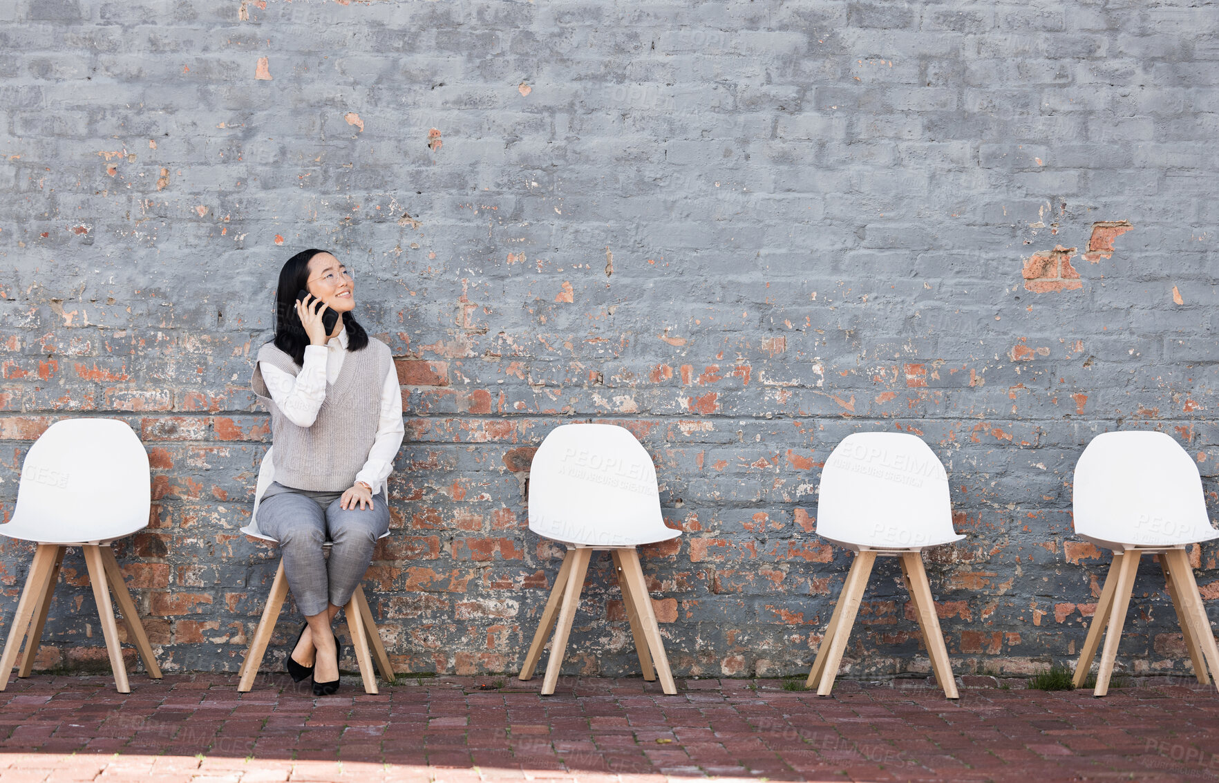 Buy stock photo Phone call, thinking in waiting room and woman with chairs, job recruitment and employment with smile in Japan. Happy person sitting on chair with smartphone, smiling and talking  with mockup space.