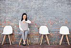 Business, Asian woman and check time for job interview, waiting and smile in line on chair. Female employee, confident lady and interviewee for work opportunity, hiring and schedule with appointment
