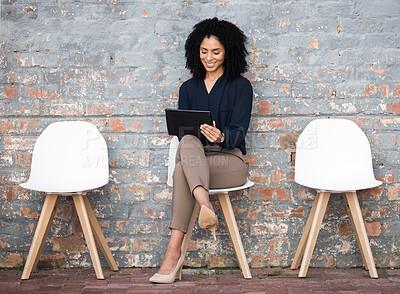 Buy stock photo Recruitment, tablet and woman sitting in line on brick wall for job opportunity, hr email and career networking. Digital technology, waiting room and black person on social media for we are hiring
