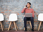 Phone call, recruitment and man on brick wall, sitting in line with hr news, job opportunity and hiring success. Smartphone, waiting room and person on technology for career networking and interview