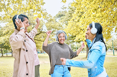 Buy stock photo Music headphones, friends and women dance at park outdoors. Senior, dancing and carefree group of elderly females with happy daughter streaming radio, podcast or fun audio song and bonding together.