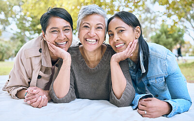 Buy stock photo Portrait, senior women and friends at park on picnic blanket, bonding and enjoying quality time together outdoors. Peace, retirement and happy group of elderly females embrace and relaxing in nature.