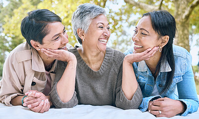 Buy stock photo Love, senior women and friends at park on picnic blanket, bonding and enjoying quality time together outdoors. Peace, retirement and happy group of elderly females embrace and relaxing in nature.