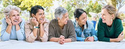 Buy stock photo Senior women, friends and relax on picnic in park for bonding, wellness and rest on blanket. Happiness, comic and group of elderly people in retirement talking, laughing and enjoying time in nature.