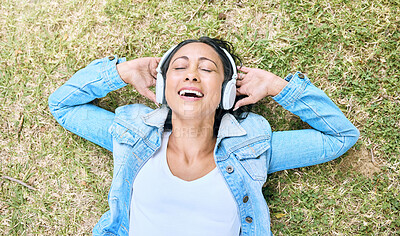 Buy stock photo Music headphones, top view and woman relax at park outdoors. Peace, calm and happy, carefree and mature female streaming radio, podcast or audio song while relaxing or resting on grass in nature.
