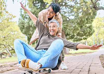 Buy stock photo Senior women, park and couple of friends together outdoor for comic fun on a skateboard while happy. People together in nature for bonding, happiness and relax on retirement holiday with support