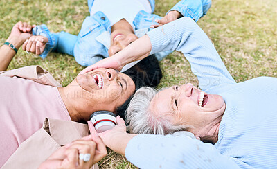 Buy stock photo Seniors, laughing or people and music headphones in silent disco, retirement friends fun or bonding community wellness. Smile, happy or elderly women lying on nature park grass and listening to radio