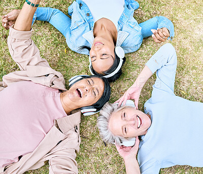 Buy stock photo Top view, senior or women and music headphones in silent disco, retirement fun or bonding community wellness. Smile, happy or elderly friends lying on grass or listening to radio in relax nature park