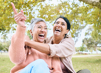 Buy stock photo Senior women, pointing or laughing in nature park, grass garden or relax environment in comic joke or funny meme. Smile, happy or couple of friends in retirement elderly bonding, hug or hand gesture