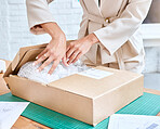 Hands, logistics and package in box for delivery, cargo or ecommerce, purchase or inventory at workshop. Hand of business owner packaging item, object or label to deliver, service or sticker sign