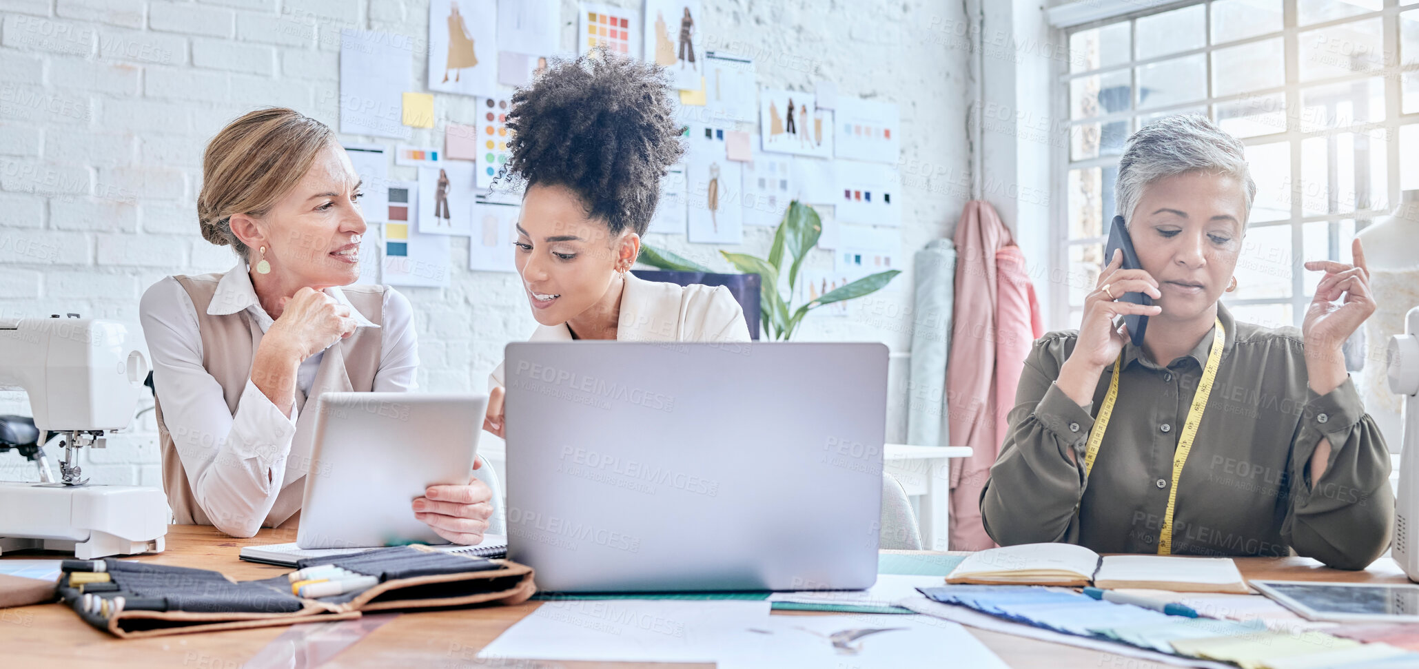 Buy stock photo Fashion, designer and teamwork of women with tablet and laptop in workshop. Group collaboration, small business and senior female tailor in boutique on phone call, chatting and networking on mobile.