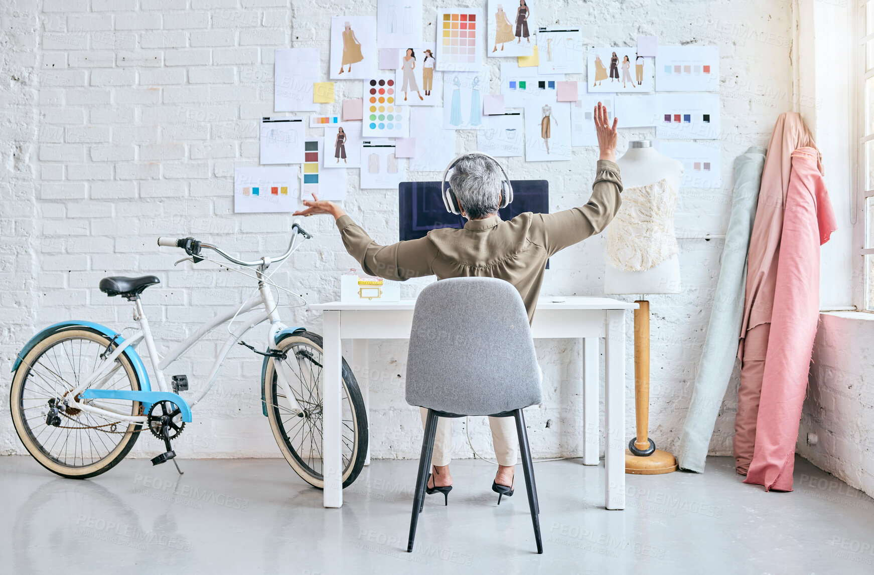 Buy stock photo Creative, startup and woman listening to music, dancing and mental health wellness in fashion design workshop. Textile industry worker, person or supplier with headphones, audio and dance at her desk