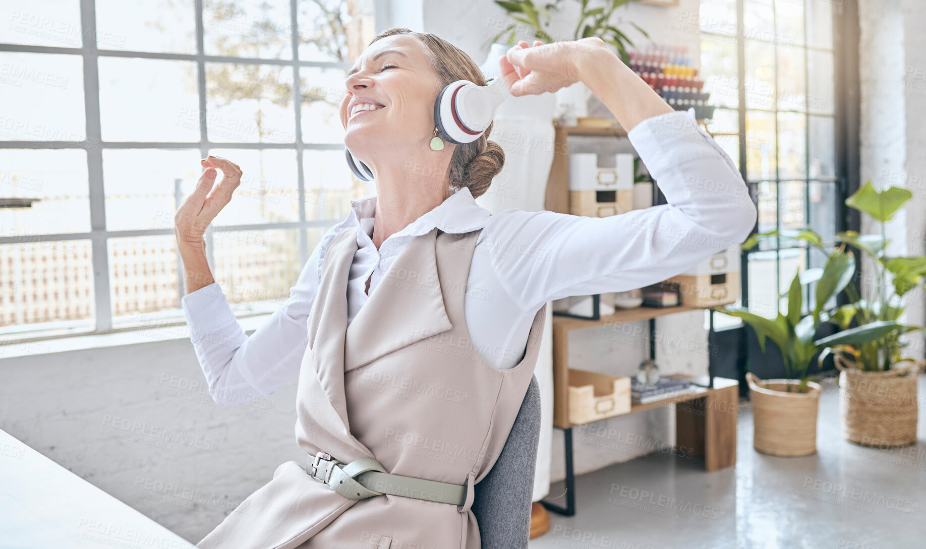 Buy stock photo Music, headphones and senior business woman dance in office, happy and excited about small business. Earphones, dancing and elderly female celebrate in design studio, cheerful and positive at a desk