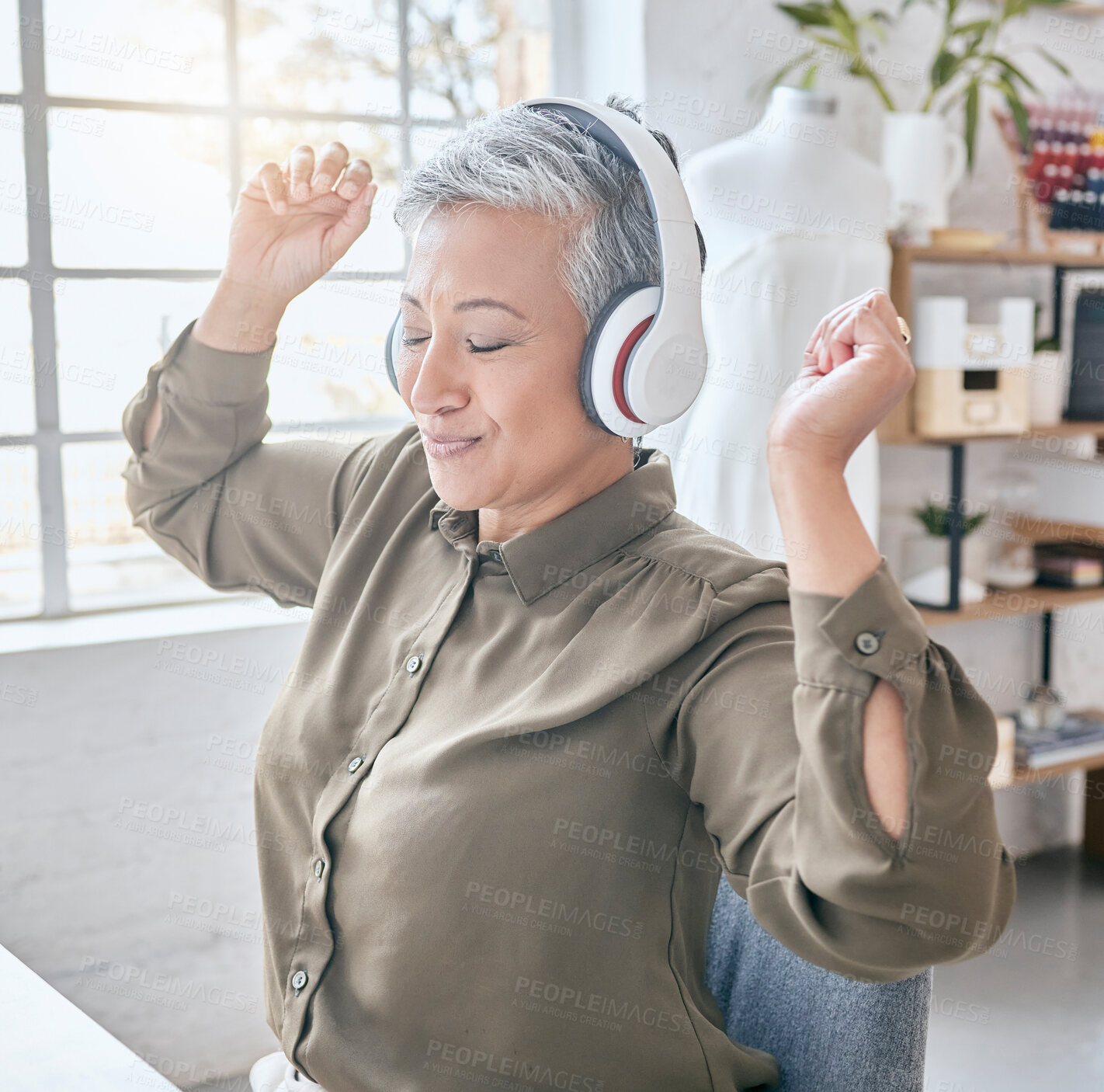 Buy stock photo Dance, headphones and music by senior business woman in office, happy and excited about small business. Earphones, dancing and elderly female celebrate in design studio, cheerful and positive at desk