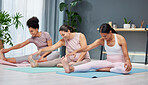 Pregnant, stretching and yoga by women on a floor for exercise, fitness and workout in a home together. Friends, pregnancy and group stretch, workout and pilates in a living room, training and cardio
