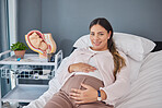 Pregnant woman, doctor consultation office and portrait of a new mother ready for ultrasound. Hospital bed, medical clinic and mama smile with happiness hold her stomach at a healthcare consultation