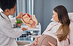 Pregnant, woman and doctor explanation with fetus in clinic for medical expertise and progress assessment. Baby, pregnancy and mom with black woman gynaecologist for update of growth development.