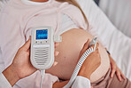 Pregnant, woman and doctor hands with heart monitor for baby healthcare, medical support or hospital gynecology. Pregnancy maternity consultation, patient stomach and gynecologist with fetal doppler