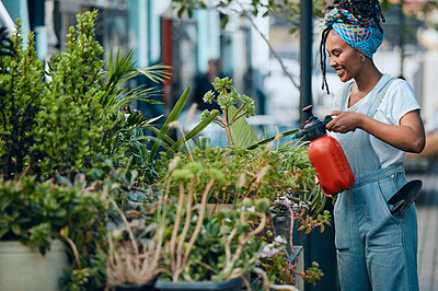 Buy stock photo Water, flowers or black woman gardening in small business shop for healthy leaf or organic plants growth. Irrigation, store manager or girl entrepreneur watering floral agriculture with a happy smile