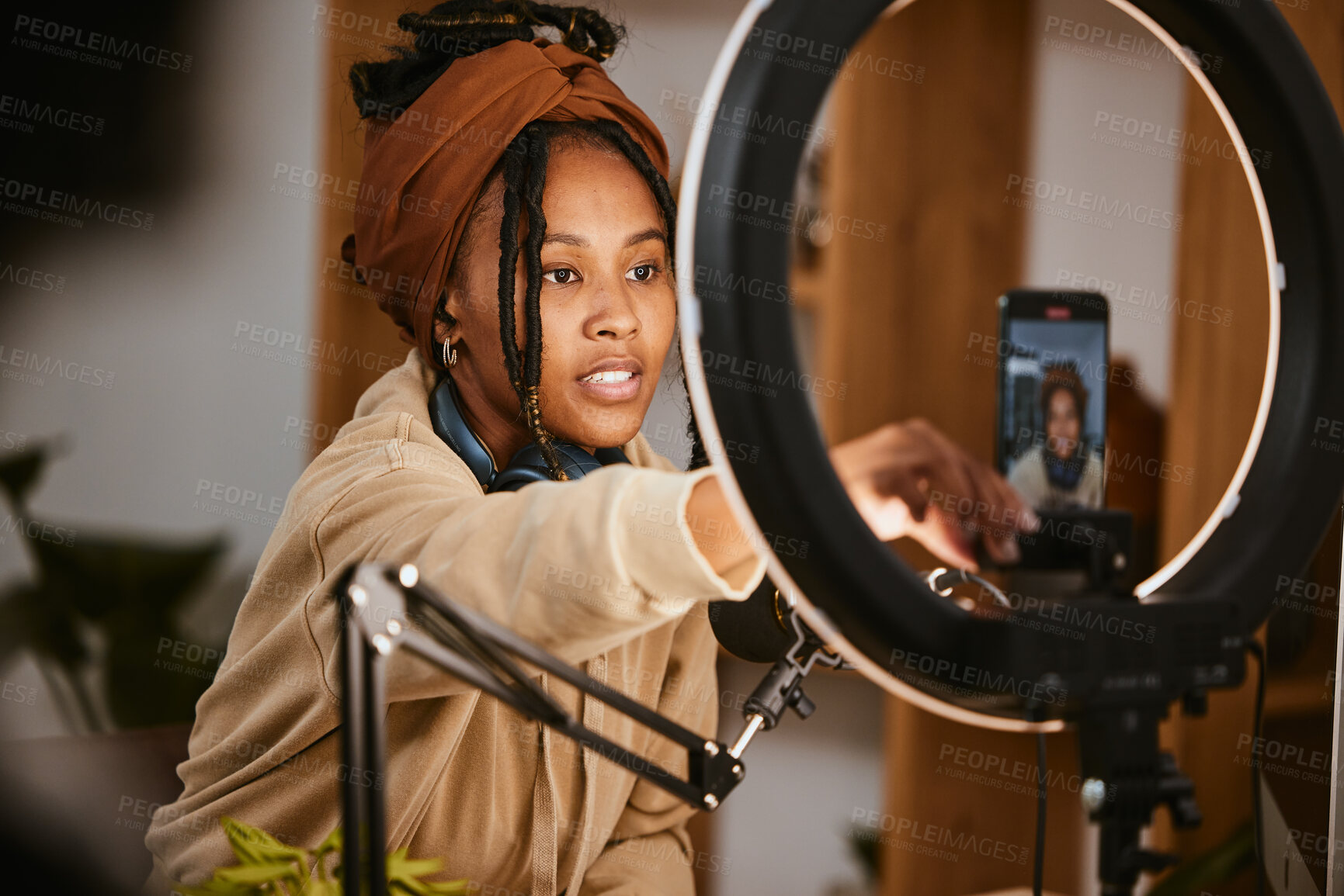 Buy stock photo Communication, phone and influencer broadcast podcast, radio talk show or speaker talking about teen culture. Presenter microphone, black woman setup streaming or speaking about online student news