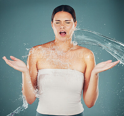 Buy stock photo Cleaning, grooming and woman surprised with a water splash isolated on a blue background in a studio. Spa, shower and shocked girl with water for skincare, hydration and dermatology on a backdrop