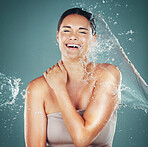 Water splash, portrait and beauty skincare for woman cleaning skin for hygiene and hydration isolated in a studio background. Self care, grooming and female dermatology for young beautiful adult