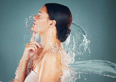 Buy stock photo Beauty, water and skincare splash on woman cleaning skin for hygiene and hydration isolated in a studio background. Self care, grooming and female dermatology for young beautiful adult