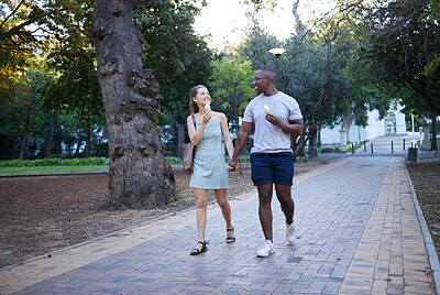 Buy stock photo Couple on date in park, ice cream and holding hands outdoor, love and commitment in relationship. Romance in nature, black man and woman eat dessert for quality time together, trust and interracial