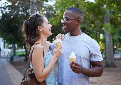 Buy stock photo Love, ice cream or couple of friends hug in a park on a romantic date in nature in an interracial relationship. Bonding, relaxed black man and happy woman enjoying a snack on a fun holiday vacation