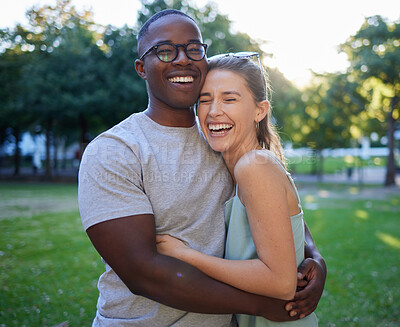 Buy stock photo Love, interracial or couple of friends hug in a park on a happy romantic date bonding in nature together. Romance, funny black man and woman laughing or enjoying quality time on a holiday vacation