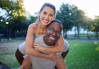 Buy stock photo Portrait, love and piggyback with an interracial couple together outdoor in a park for bonding or a date. Summer, diversity and smile with a man and woman happy outside in nature while dating