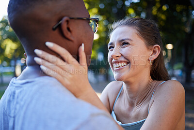 Buy stock photo Love, happy or couple of friends in a park bonding on a romantic date in nature in an interracial relationship. Embrace, funny black man and young woman enjoying quality time on a holiday vacation