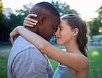 Love, forehead and interracial couple, outdoor and quality time for bonding, romantic and loving together. Romance, black man and woman hug, embrace and relationship with intimate and facial contact