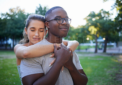 Buy stock photo Love, peace or couple of friends hug in a park bonding on a relaxing romantic date in nature together. Interracial, young black man and happy woman embrace enjoying quality time on a holiday vacation