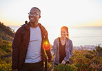 Interracial couple, workout and hiking exercise in sunset on a mountain as morning fitness in nature. Happy people, man and woman in a relationship training for health and wellness together