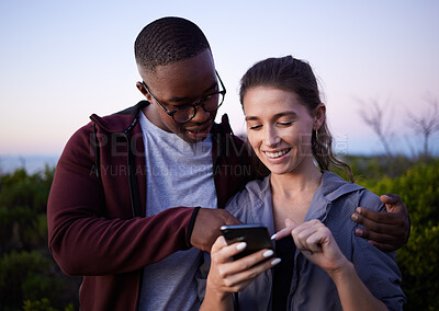 Buy stock photo Hiking, travel and couple with phone on mountain for location, gps mobile app and health tracking. Fitness, dating and interracial man and woman with smartphone for adventure, freedom and nature hike